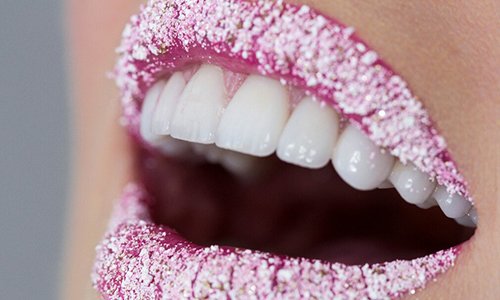 Close up of smile whose lips are covered in sugar to illustrate this smile design dental lab's case studies